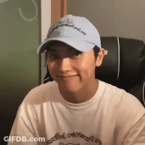 Young Man In Hat And White Shirt Smiling GIF