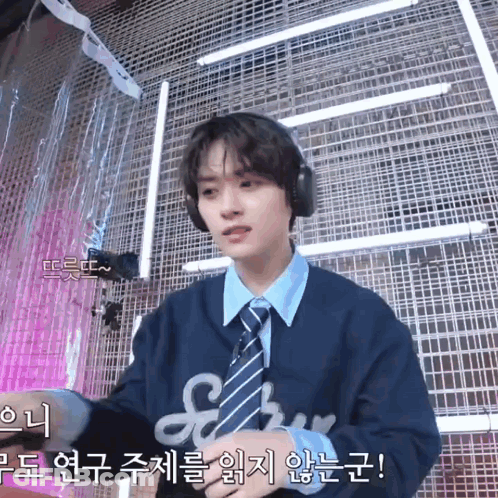 Young Man In Headphones And Tie At Microphone GIF