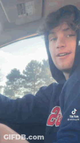 Young Man In Hoodie Driving Car Smiling GIF