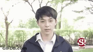 Young Man In Jacket And White Shirt In Park GIF
