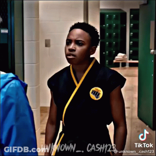 Young Man In Karate Uniform In Hallway GIF