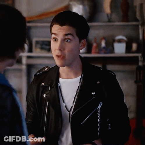 Young Man In Leather Jacket Talking To Another GIF