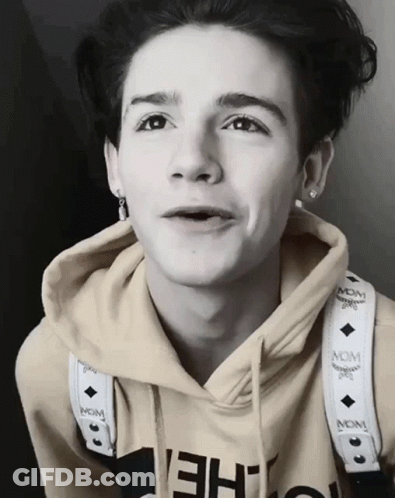 Young Man In McM Hoodie With Neck Strap GIF