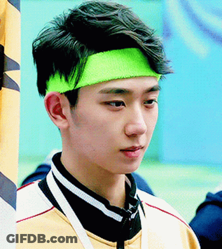 Young Man In Neon Green Headband Looking At Camera GIF