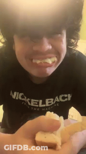 Young Man In Nickelback Shirt Holding Bread GIF
