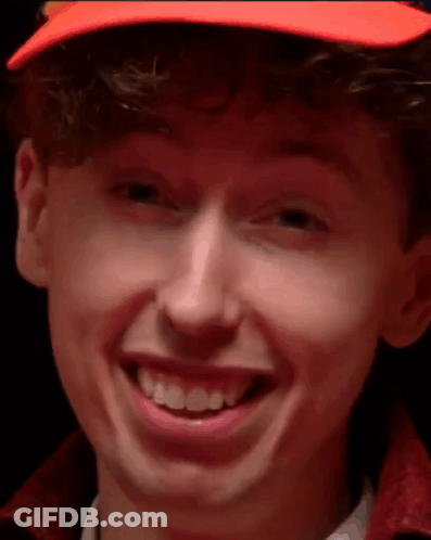 Young Man In Orange Hat Smiling Close Up GIF