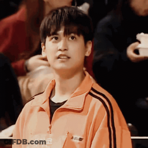 Young Man In Orange Jacket Saying A GIF