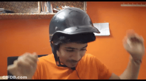 Young Man In Orange Shirt And Black Helmet GIF