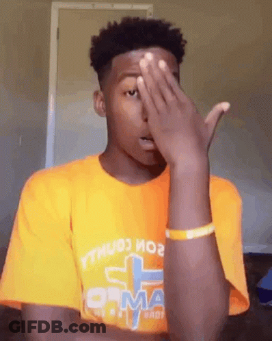 Young Man In Orange T-Shirt Covering Face GIF