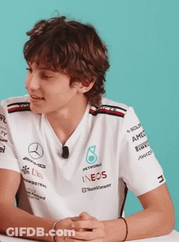 Young Man In Petronas Shirt At Desk GIF