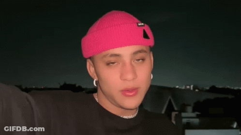 Young Man In Pink Hat And Black Shirt GIF