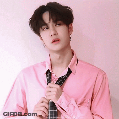 Young Man In Pink Shirt Adjusting Tie GIF