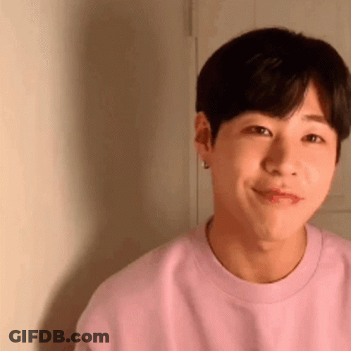 Young Man In Pink Sweater Smiling GIF