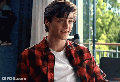 Young Man In Plaid And White Shirt Smiling GIF