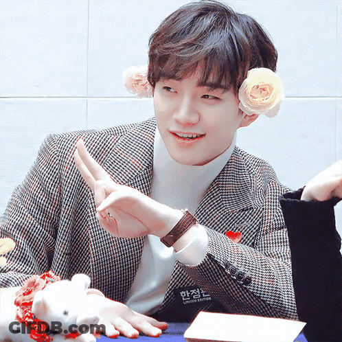 Young Man In Plaid Jacket With Flower In Ear GIF