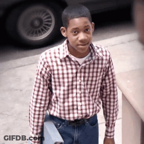 Young Man In Plaid Shirt And Jeans On Sidewalk GIF