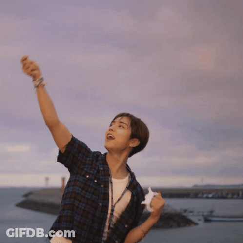 Young Man In Plaid Shirt By Ocean GIF