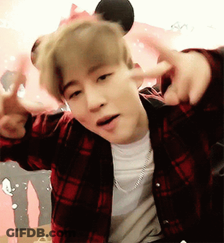 Young Man In Plaid Shirt Giving Peace Sign GIF