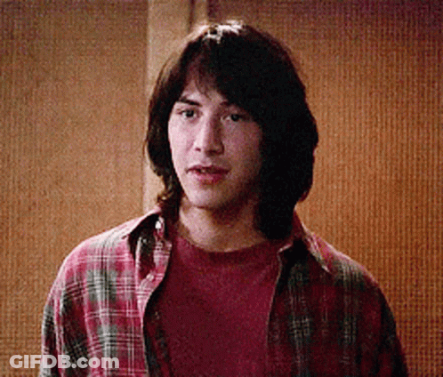 Young Man In Plaid Shirt Looking At Camera GIF