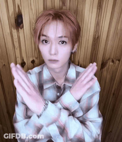 Young Man In Plaid Shirt Making Cross With Hands GIF