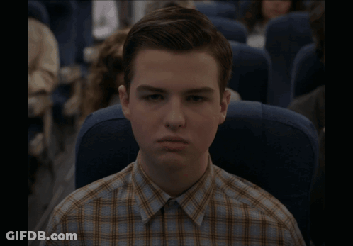 Young Man In Plaid Shirt Sitting On Plane GIF
