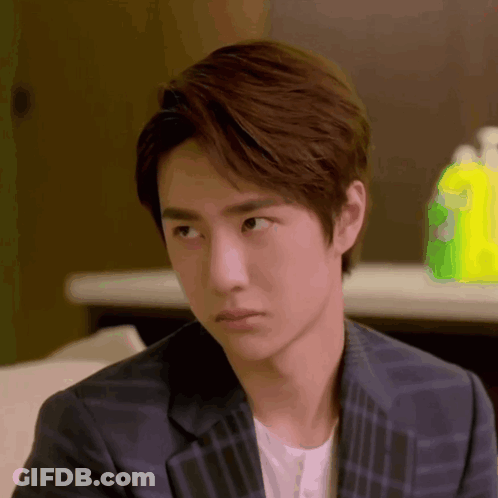 Young Man In Plaid Suit Looking GIF