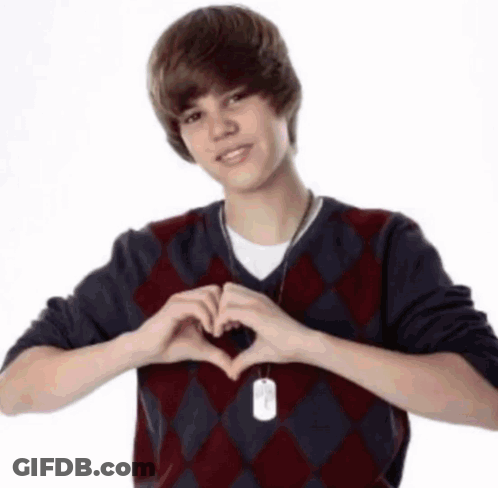 Young Man In Plaid Sweater Making Heart GIF