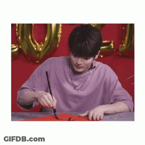 Young Man In Purple Shirt Holding Brush GIF