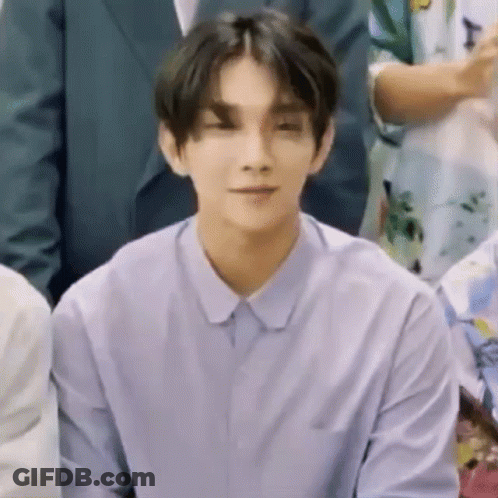 Young Man In Purple Shirt Sitting With Group GIF