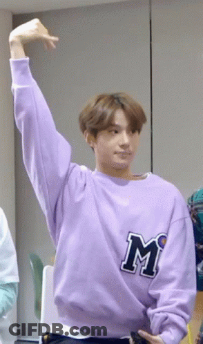 Young Man In Purple Sweatshirt With Letter M GIF
