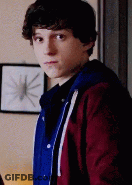 Young Man In Red And Blue Jacket In Front Of Spider Picture GIF