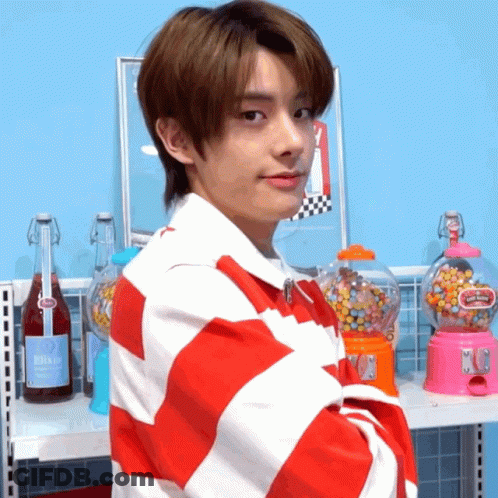 Young Man In Red And White Striped Shirt At Gumball Machine GIF
