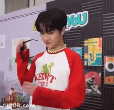 Young Man In Red And White Sweater Holding Sunglasses GIF
