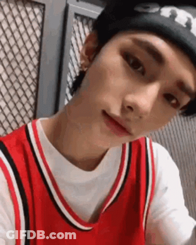 Young Man In Red Basketball Jersey And Black Beanie GIF