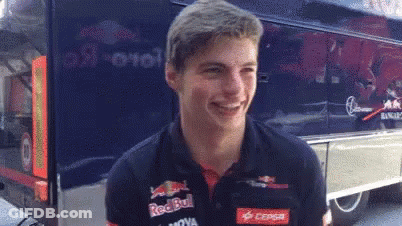 Young Man In Red Bull Shirt Smiling Near Bus GIF