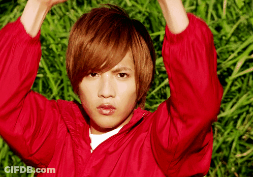 Young Man In Red Jacket In Grass Field GIF