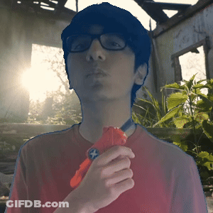 Young Man In Red Shirt And Glasses Holding Red Toy Gun GIF