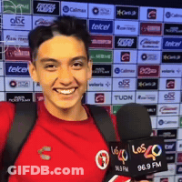 Young Man In Red Shirt Holding Microphone Smiling GIF