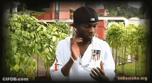 Young Man In Red Shirt Looking At Camera GIF