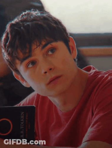Young Man In Red Shirt Reading Laura Tolkien GIF