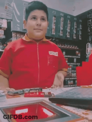 Young Man In Red Shirt Sitting At Counter GIF