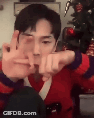 Young Man In Red Sweater Making Peace Sign GIF