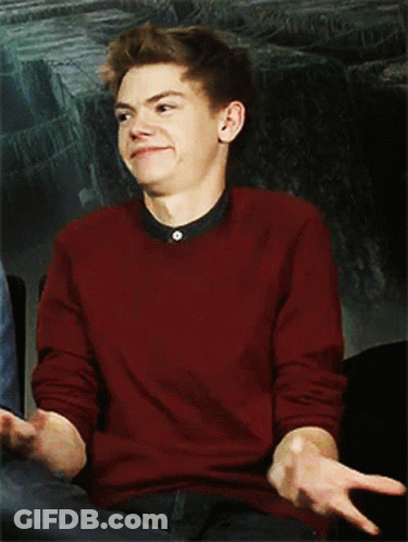 Young Man In Red Sweater Sitting In Chair GIF