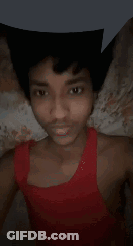 Young Man In Red Tank Top Lying On Bed GIF