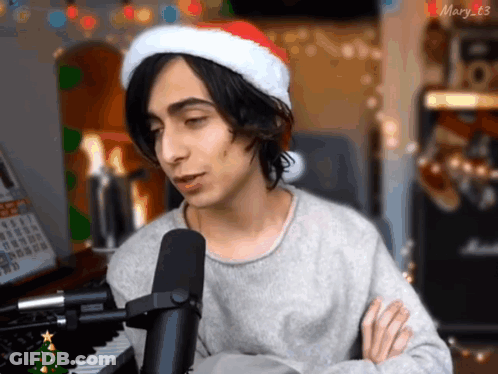 Young Man In Santa Hat Singing GIF