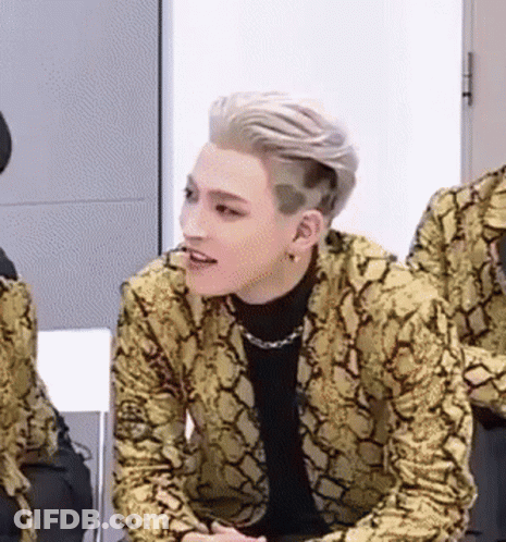Young Man In Snakeskin Jacket Sitting In Chair GIF