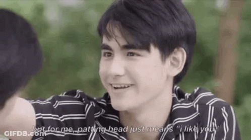 Young Man In Striped Shirt Smiling Talking To Another Man GIF