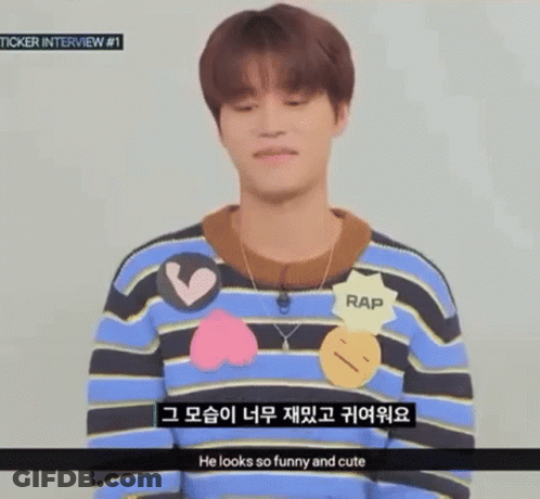 Young Man In Striped Sweater And Necklace Talking Foreign Language GIF