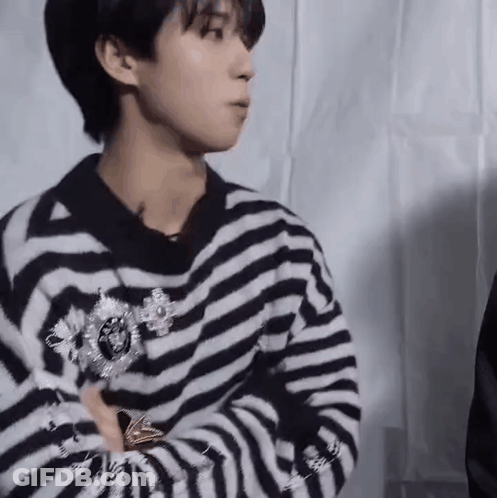 Young Man In Striped Sweater With Brooch GIF