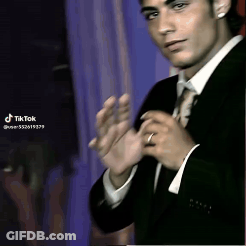 Young Man In Suit And Tie Clapping GIF